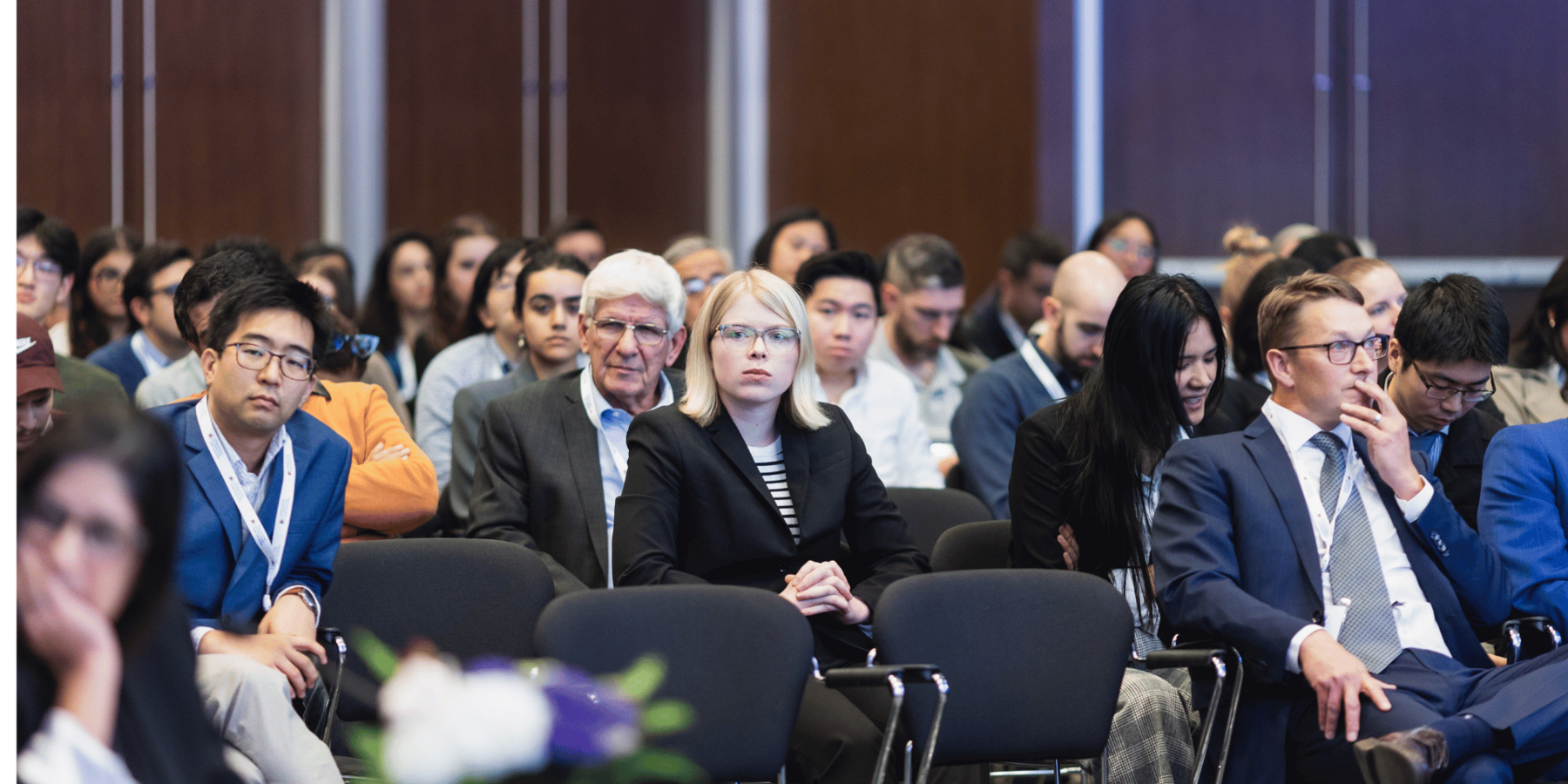 a crowd of people listen to a presentation