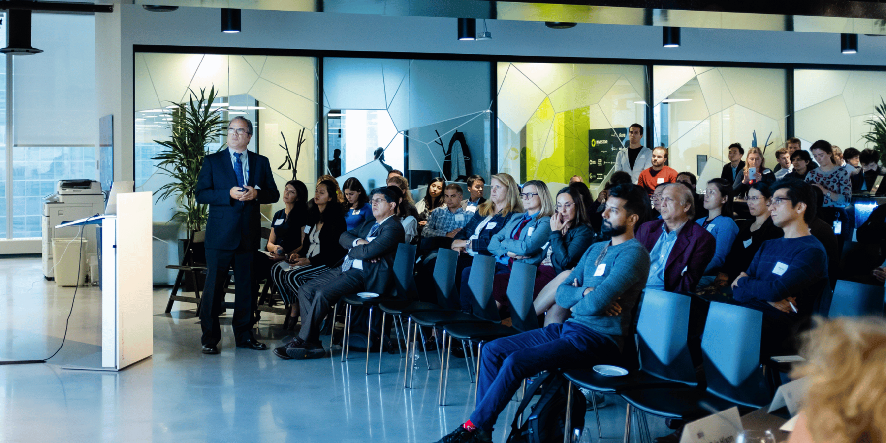 a crowd listens to a presentation