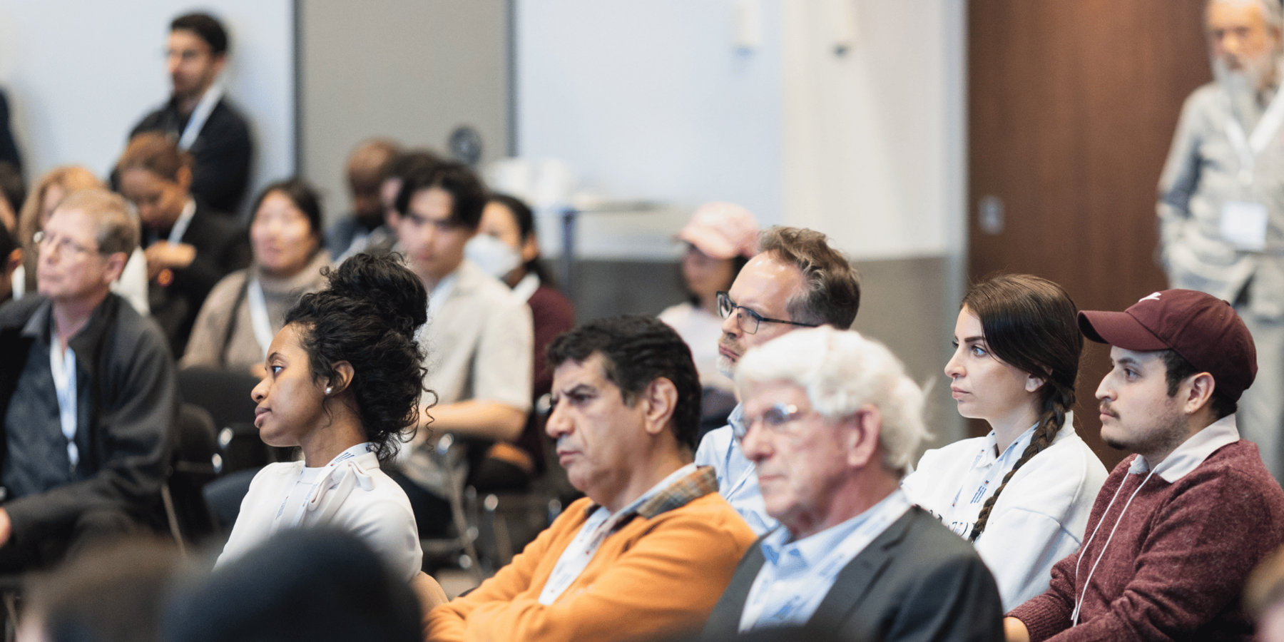 a crowd listens to a presentation