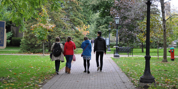 Students walk along a path on campus