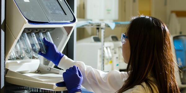 Scientist works at a lab bench.