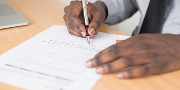 person signs a document