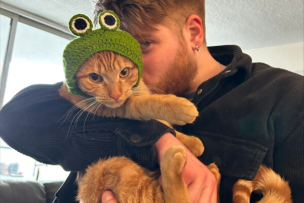 Kieran Coppens holding a cat.