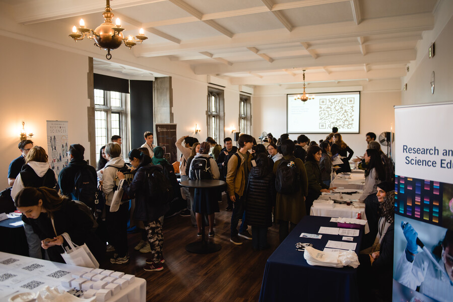 A crowd of people visiting booths