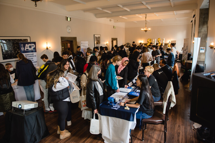 A crowd of people visiting booths