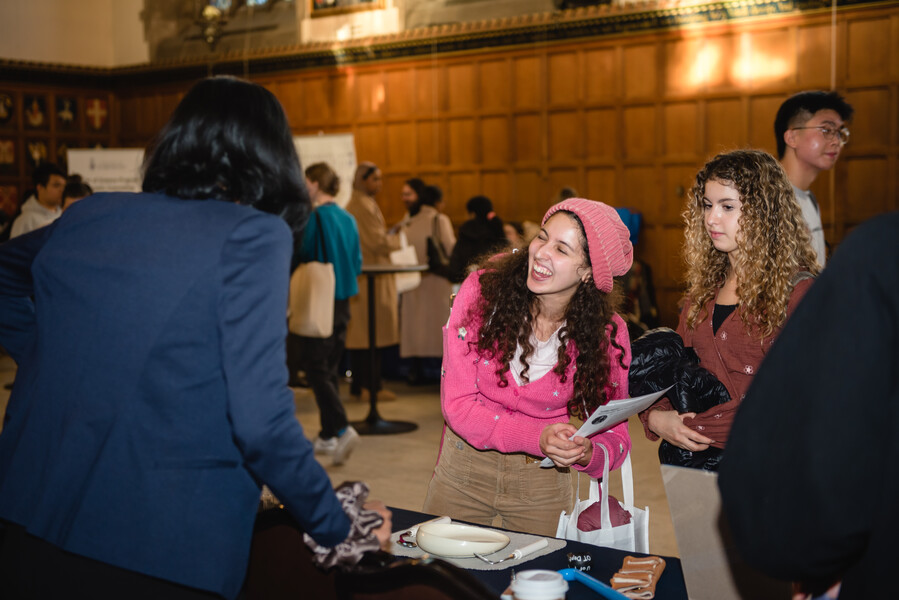 People smiling while standing at a table